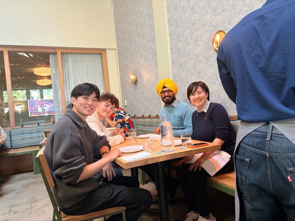 Ember teammates gathered around the table at a team dinner