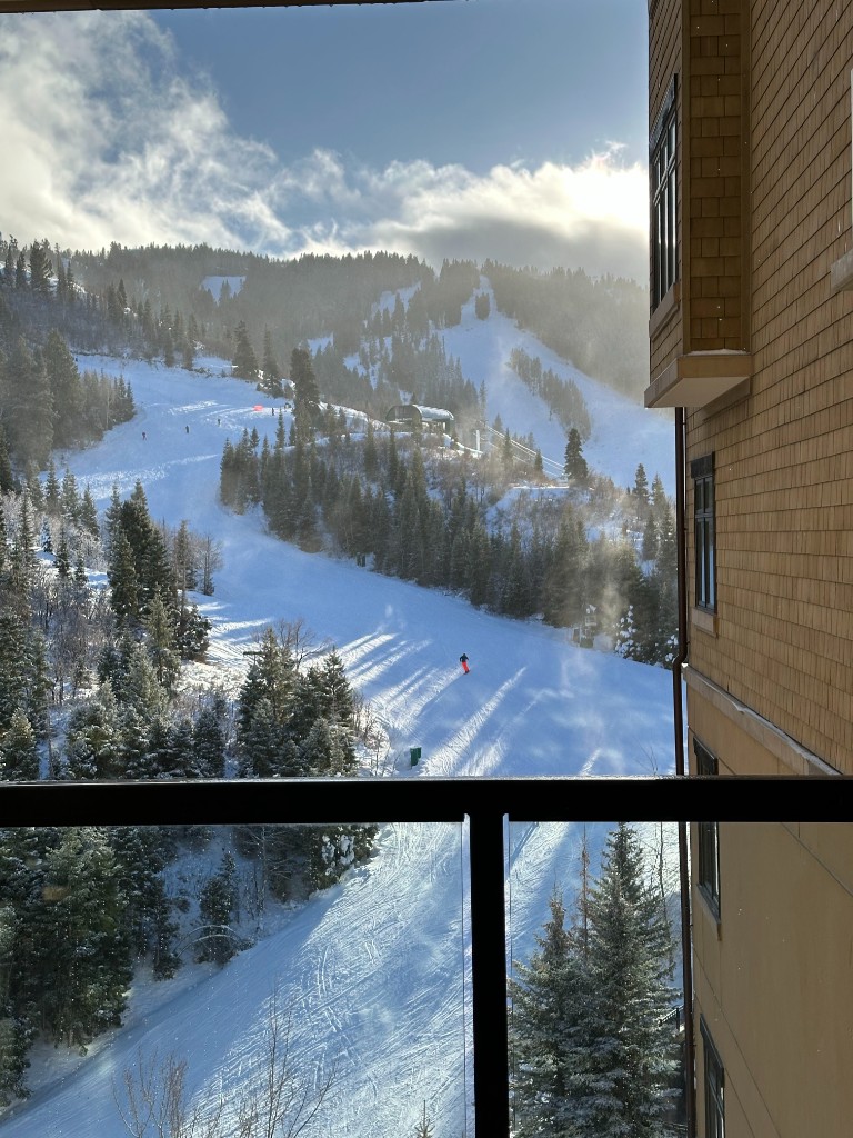 View of a snowy mountain ski slope from the company offsite lodge
